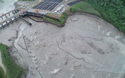 Rain-swollen rivers shut down key dams, raising fears of power instability